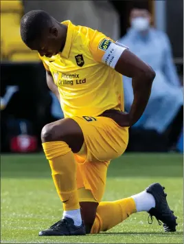  ??  ?? Livingston’s Marvin Bartley takes the knee before a game against Hibernian