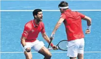  ?? GETTY IMAGES ?? Double delight . . . World No 1 Novak Djokovic (left) and Filip Krajinovic, of Serbia, celebrate winning their group A doubles match against Milos Raonic and Denis Shapovalov, of Canada, during day one of the ATP Cup in Melbourne yesterday.