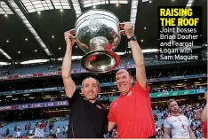  ??  ?? RAISING THE ROOF Joint bosses Brian Dooher and Feargal Logan with Sam Maguire