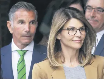  ?? STEVEN SENNE — THE ASSOCIATED PRESS ?? Clothing designer Mossimo Giannulli and wife, actress Lori Loughlin, both will serve prison terms in the college bribery scheme.