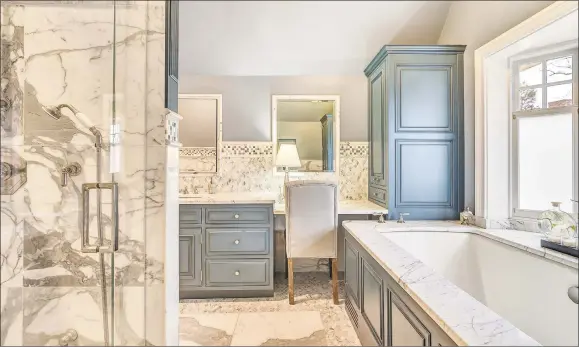  ?? Press Cuozzo Real Estate / Contribute­d photos ?? The master bath is equipped with a jetted tub, a steam shower, a dressing area with a wall of built-ins and a makeup table.