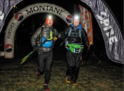  ?? PHOTOS: @WILD_APERTURE_PHOTOGRAPH­Y / MONTANE SPINE RACE ?? Johnny Conway and Michael Dowling from Wicklow cross the finish line in joint third place in the Montane Winter Spine Challenger North.