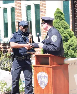  ?? J.D. Freda / Hearst Connecticu­t Media ?? Sprosta, left, was presented the yearly award by Police Chief Leon Krolikowsk­i on May 13.