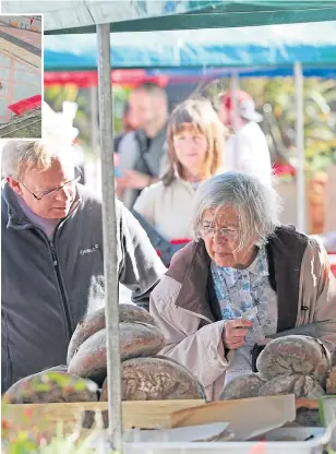  ??  ?? The bread stall attracts customers. Top: The market set out in City Square.