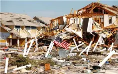  ??  ?? An American flag flies amongst rubble left in the aftermath of Hurricane Michael in Mexico Beach, Florida, US. — Reuters photo