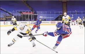  ?? Bruce Bennett / Associated Press ?? The Rangers’ Chris Kreider, right, shoots as the Penguins’ John Marino (6) defends Saturday.