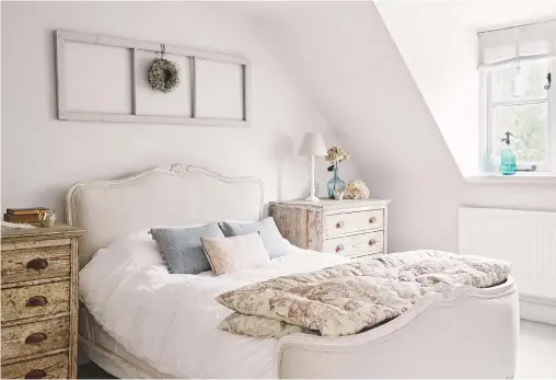  ??  ?? Guest bedroom
A wreath, which Hanna made, hangs from a frame similar to the towel ladder in the bathroom. Hanna also reupholste­red the bed. Flanders Linen upholstery fabric, eiderdown,
both Sarah Hardaker. Bedlinen, H&M.
Chests of drawers,
Stenvall...