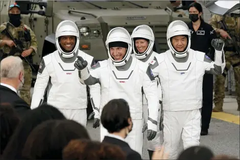  ?? JOHN RAOUX — THE ASSOCIATED PRESS ?? Astronauts, from left, Victor Glover, Michael Hopkins, Shannon Walker, and Japan Aerospace Exploratio­n Agency astronaut Soichi Noguchi wave to family members as they leave the Operations and Checkout Building for a trip to Launch Pad 39-A and planned liftoff on a SpaceX Falcon 9 rocket with the Crew Dragon capsule on a six-month mission to the Internatio­nal Space Station Nov. 15 at the Kennedy Space Center in Cape Canaveral, Fla.