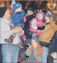  ?? DAVID JALA/CAPE BRETON POST ?? The crowd reacts to the lighting of the gigantic Christmas tree that this year sits on the boardwalk behind the Civic Centre on the Sydney waterfront.