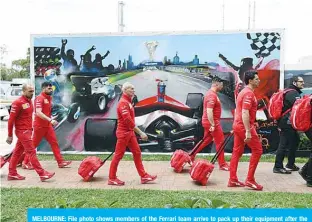  ??  ?? MELBOURNE: File photo shows members of the Ferrari team arrive to pack up their equipment after the Formula One Australian Grand Prix was cancelled in Melbourne on March 13, 2020 over fears about the spread of coronaviru­s after a McLaren team member tested positive. —AFP