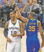  ?? RONALD CORTES/THE ASSOCIATED PRESS ?? Spurs forward LaMarcus Aldridge, left, reacts after missing a shot next to thee Warriors’ Kevin Durant on Saturday.