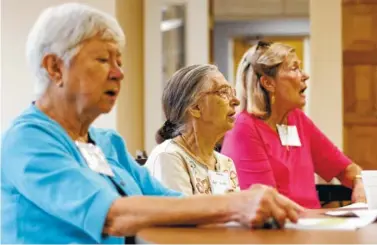  ?? STAFF PHOTOS BY C.B. SCHMELTER ?? Volunteer Faye Jordan, center, sings along during the Let’s Sing From Memory event at Northside Presbyteri­an Church.