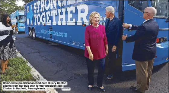  ?? REUTERS ?? Democratic presidenti­al candidate Hillary Clinton alights from her bus with former president Bill Clinton in Hatfield, Pennsylvan­ia.