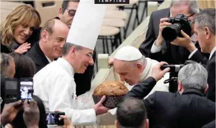  ??  ?? POPE Francis smells a panettone during the weekly general audience in Paul VI Hall at the Vatican yesterday. The traditiona­l Italian Christmas cake was presented as a gift to the pontiff, who celebrated his 82nd birthday on Monday. | REUTERS