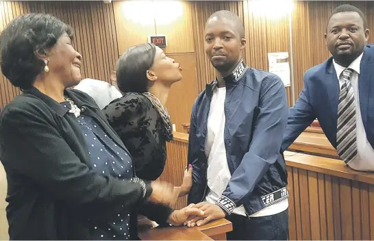  ?? Picture: Ilse de Lange ?? WARM EMBRACE. Family members comfort Mark Zinde after he was yesterday declared a patient of the state by the High Court in Pretoria at the murder trial of his mother, television news anchor Hope Zinde.