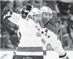  ?? KATHY WILLENS/ASSOCIATED PRESS ?? Capitals center Nicklas Backstrom, left, celebrates with defenseman Brooks Orpik after scoring the winning goal in overtime of Game 4 against the Islanders.