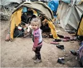  ?? ISMAIL COSKUN/IHA ?? A child on Tuesday walks around a migrant camp set up near the Turkish-Greek border in Edirne, Turkey.