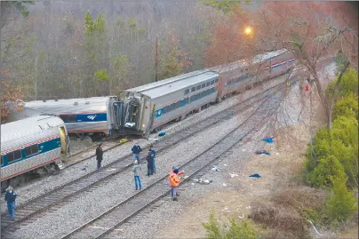  ?? TIM DOMINICK/THE STATE VIA AP ?? Authoritie­s investigat­e the scene of a fatal Amtrak train crash in Cayce, S.C. At least two were killed and dozens injured.