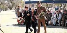  ?? Photo: Matthew Newton ?? IN MEMORY: Helping Richard McKenna, one of the last surviving veterans of the Battle of Milne Bay, lay a wreath at the Milne Bay Memorial Service on Sunday are (left) Councillor Carol Taylor and (right) 25/49th Battalion Captain Sean Caughey.