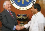  ?? BULLIT MARQUEZ / AP ?? U.S. Secretary of State Rex Tillerson shakes hands Monday with Philippine President Rodrigo Duterte at Malacanang Palace in Manila.