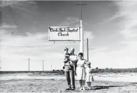  ?? Courtesy Anne Marie Miller ?? Anne Marie Miller and her parents pictured outside of their church. Her family’s life revolved around the church.