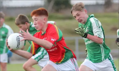  ??  ?? Mikey Webster of Starlights on the move away from Cormac Doyle (Naomh Eanna) during Thursday’s second Under-14 semi-final.