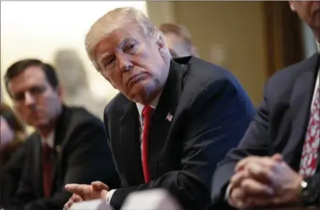  ?? EVAN VUCCI — THE ASSOCIATED PRESS ?? President Donald Trump listens during a meeting with steel and aluminum executives in the Cabinet Room of the White House Thursday in Washington. Trump’s announceme­nt that he will impose stiff tariffs on imported steel and aluminum has upended...