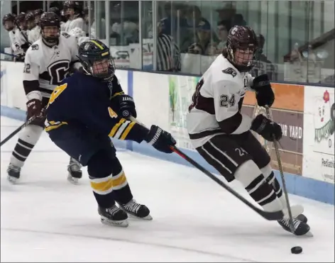  ?? JULIA MALAKIE — LOWELL SUN ?? Chelmsford’s Cole Pelkey (24) tries to skate past Andover’s Nik Previte in a boys hockey clash Saturday at the Chelmsford Forum in Billerica. The game ended in a 2-2tie.