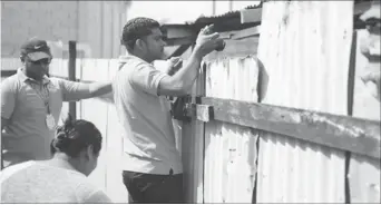  ??  ?? Officers of the EPA taking photograph­ic evidence of the conditions under which pigs are being reared in Lusignan. (DPI photo)