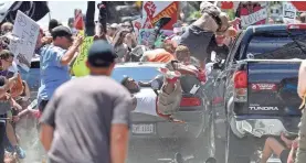  ?? RYAN M. KELLY/THE DAILY PROGRESS VIA AP ?? A vehicle drives into protesters last Aug. 12 in Charlottes­ville, Va.