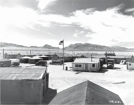  ?? COURTESY OF LANL ?? The first atomic bomb was tested at Trinity Site on a section of the Alamogordo Bombing and Gunnery Range, now White Sands Missile Range. The Packard Clipper Custom Limousine, just to the left of the flagpole, seated 15 and was used to transport scientists, senior military officers and dignitarie­s. The vehicle has been restored and is on exhibit at the National Museum of Nuclear Science and History in Albuquerqu­e.