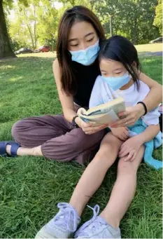  ??  ?? Jennifer Lin tutors her sister Angie Lin, 9. The older Lin is the founder and executive director of Children of Steel, a tutoring service for K-5 children started and operated by students at Allderdice High School.