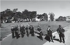  ?? Associated Press ?? n San Francisco Police Officers guard an entrance to Alamo Square Park in San Francisco, Saturday. San Francisco officials took further steps Saturday to prevent violence ahead of a planned news conference by a right-wing group.