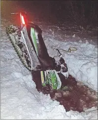  ?? JESSICA DESROCHES PHOTO ?? An 800 Crossfire snowmobile awaits rescue after dropping into a water hole Wednesday evening in Miscouche. The riders were thrown from the sled upon impact.