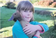  ??  ?? Making friends cuddles a duck Deia Wilkinson (10) from Thornhill