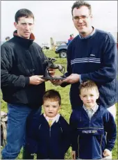  ??  ?? Anthony O’Riordan, representi­ng sponsors, The Park Arms Pub, Doneraile, presenting the leading rider award to JT McNamara at the Doneraile pointto-point meeting in Dromahane in 2000. Also present are Anthony’s nephews, Ciarán and Colin Ryan.