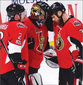  ?? CP PHOTO ?? Ottawa Senators defencemen Dion Phaneuf (2) and Marc Methot (3) congratula­te goaltender Craig Anderson after their victory Tuesday.