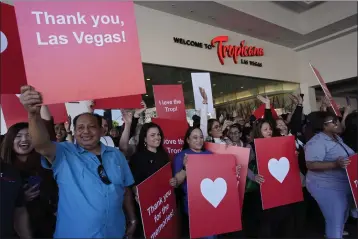  ?? JOHN LOCHER — THE ASSOCIATED PRESS ?? Tropicana employees hold up signs during a ceremony marking the closing of the historic property at the Tropicana hotel-casino on Tuesday in Las Vegas. The hotel-casino is slated for demolition in October to make room for a $1.5 billion baseball stadium for the A's.