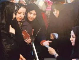  ?? Abedin Taherkenar­eh European Pressphoto Agency ?? WOMEN IN TEHRAN prepare to vote in parliament­ary elections, which were largely about candidates positionin­g themselves for the 2013 presidenti­al race.