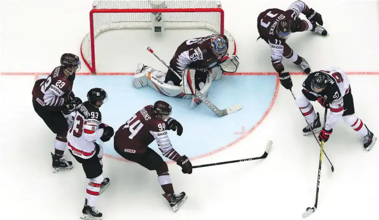  ?? — GETTY IMAGES ?? Connor McDavid, right, was the overtime hero for Canada Monday as the men’s national team beat Latvia 2-1 at the world championsh­ip in Herning, Denmark.