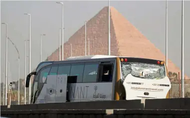  ?? — Reuters ?? Close call: The damaged bus at the site of the blast near the Giza pyramids in Cairo.