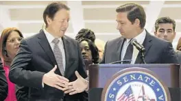  ?? AP 2019 ?? Gov. Ron DeSantis shakes Florida Senate President Bill Galvano’s hand at the end of session in Tallahasse­e. Several corporate tax cuts are scheduled to expire at the end of next year. But businesses are pushing leaders to turn those temporary cuts into permanent breaks.