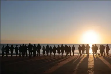  ?? AP PHOTO BY JEREMIAS GONZALEZ ?? World War II reenactors gather on Omaha Beach in Saint-laurent-sur-mer, Normandy, France Monday, June 6, 2022, the day of 78th anniversar­y of the assault that helped bring an end to World War II.