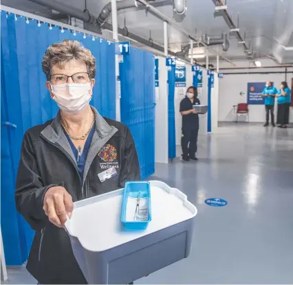  ?? Picture: Nev Madsen. ?? COEM IN: More than 1000 people were administer­ed the Covid vaccine by registered nurse Di Utschink and her colleagues at the Covid clinic at Clifford Gardens shopping centre.