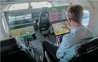  ?? ?? Xwing CTO Maxime Gariel checks on the systems in a Cessna 208B Grand Caravan which has been outfitted with autonomous flying equipment.