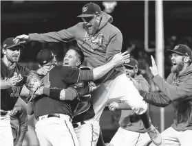  ?? Patrick Smith / Getty Images ?? The Nationals let loose after clinching their first World Series berth, leaving the Mariners as the only present-day franchise never to reach the Series.