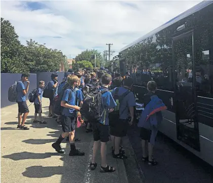  ?? Photo / Meghan Lawrence ?? Rosmini College students crowd on to the bus after school on Auckland’s North Shore.