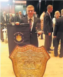  ??  ?? Ross Dunne, Cory first horn, with the 2016 British Open Shield