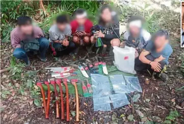  ??  ?? Taken into custody: Some of the weapons and tools that were seized from the detained Cambodians. (Inset) DCP Mastor.