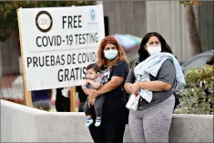  ?? (AP Photo/Marcio Jose Sanchez) ?? Two women and a child wait to take a coronaviru­s test Wednesday at a mobile testing site at Charles Drew University of Medicine and Science in Los Angeles. California's confirmed coronaviru­s cases have topped 409,000, surpassing New York for most in the nation.